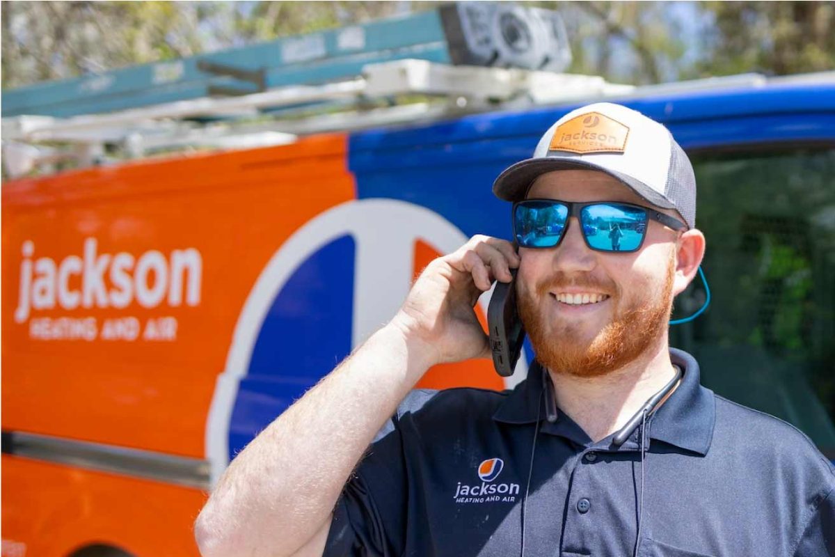 Jackson Services technician beside a service vehicle